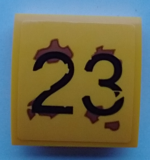 15068pb343 - Slope, Curved 2 x 2 x 2/3 with Black '23', Medium Nougat Rust Splotches Pattern (Sticker) - Set 70423