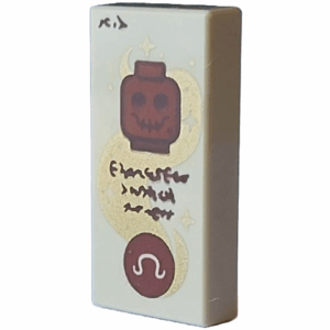 3069pb1243 - Tile 1 x 2 with Reddish Brown Minifigure Head Skeleton and Circle with Omega Sign, Gold Swirl with Stars and Dark Brown Text Pattern (Dungeons & Dragons Spell Scroll of Speak with Dead)